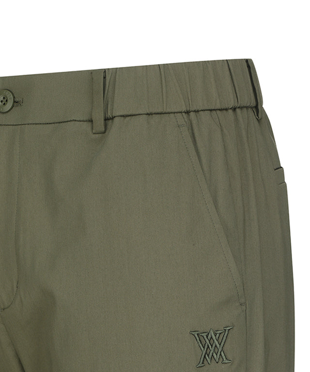 ANEW Golf Men Loose Fit Selvage Roll-Up Long Pants displayed on a hanger, showcasing the relaxed fit and stylish roll-up design.